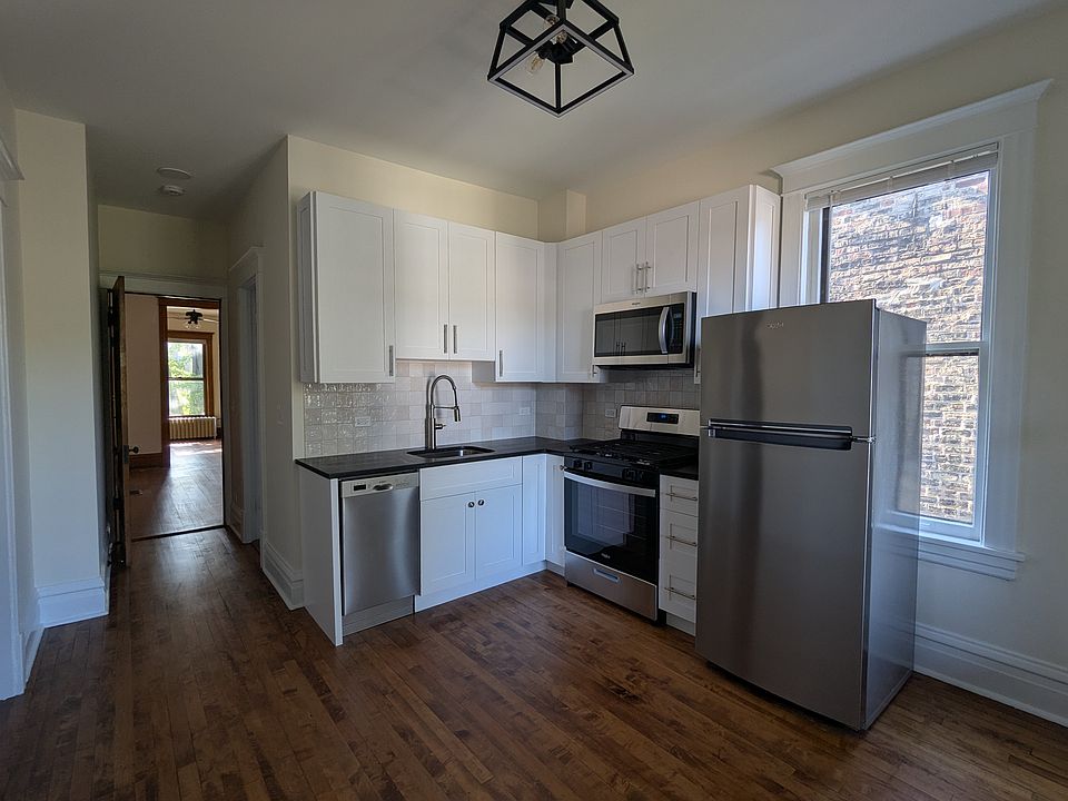 Brand new kitchen appliances with granite countertop and tile back splash