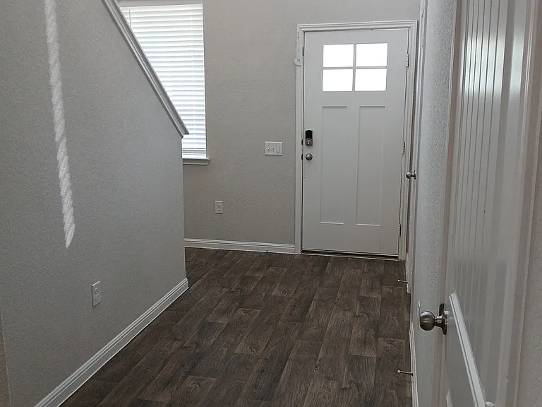 A welcoming entryway with luxury vinyl plank floors and natural light.
