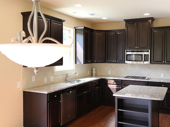 Large kitchen with granite countertops and stainless steel appliances. Ton of storage space as well!
