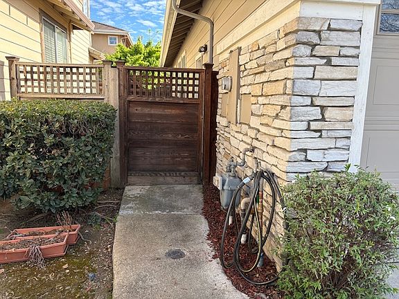 Separate side yard gated wooden entry way.