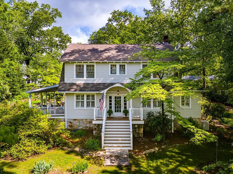 The home sits high on a corner lot above the street. Its expansive yard has wonderful mature trees and space to enjoy the outdoors.