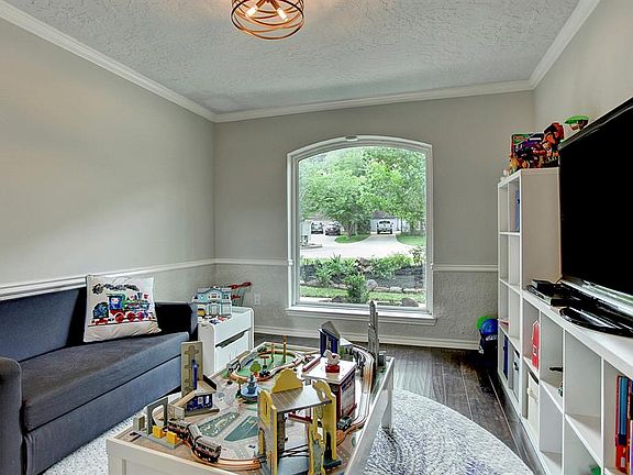 This formal dining space right off the kitchen is currently being used as a child's playroom. This is perfect for watching littl