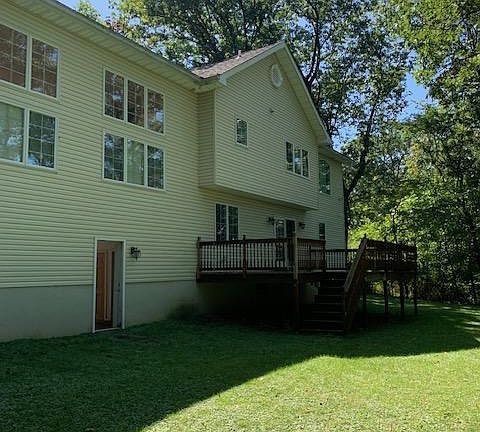 DECK OFF KITCHEN OVERLOOKING SPACIOUS BACKYARD