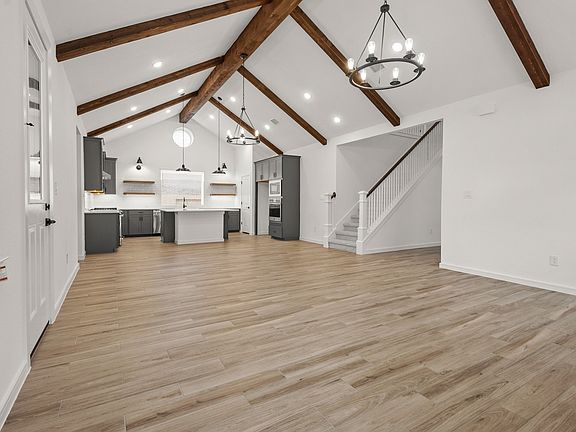 Great room featuring vaulted ceiling stained ceiling beams