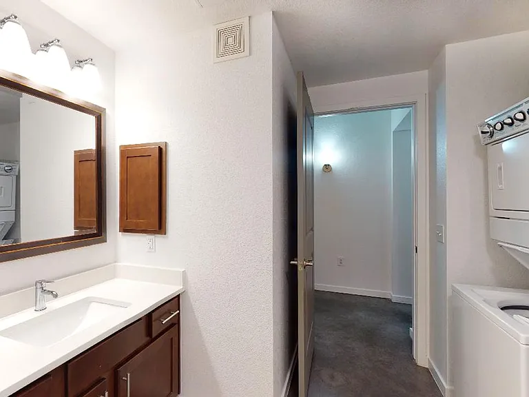 Apartment bathroom with tile flooring.