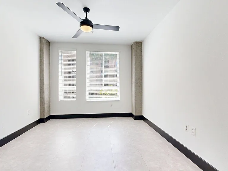 Spacious apartment Bedroom with Wood-Style Flooring.