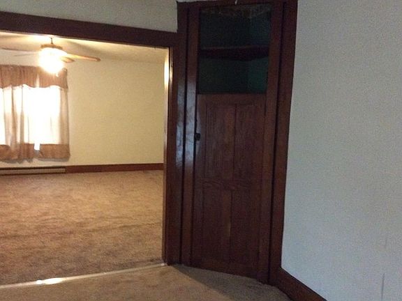 Dining room with corner built in adds character looking into living room