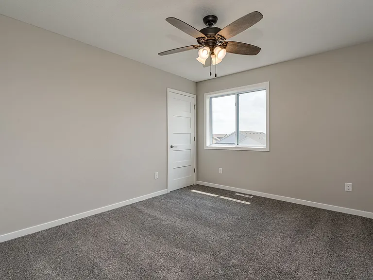 Large secondary bedrooms with walk in closet ceiling fan.