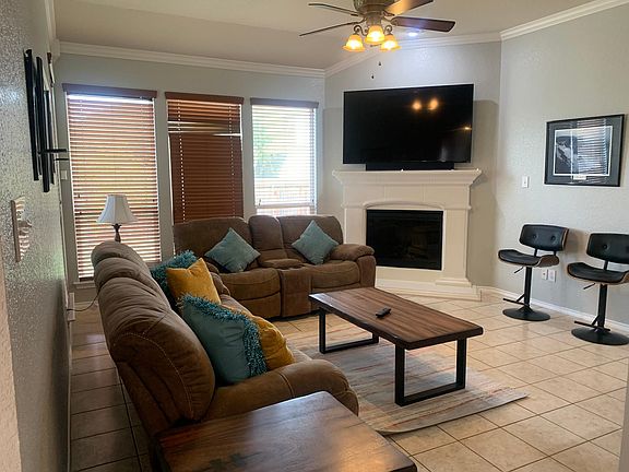 Living area with 65 inch TV, reclining couches, ceiling fan and tiled flooring make this the spot for relaxing!