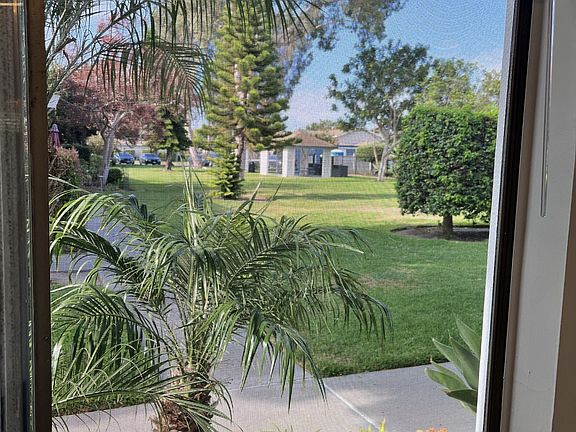 greem belt view from your front living room window. This complex has a massive greenbelt area, including picnic are. Nice pool close but not too close and club house. Like resort living!