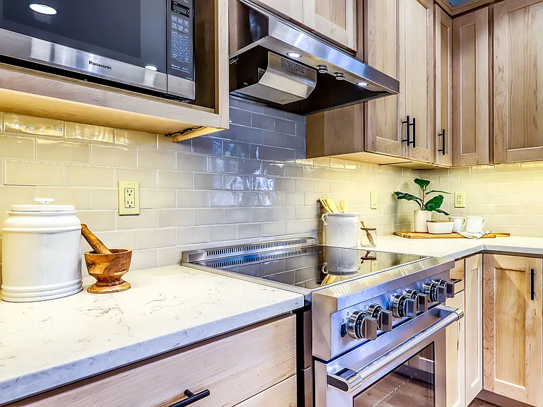 Kitchen with quartz countertops, maple cupboards, and all stainless steel appliances