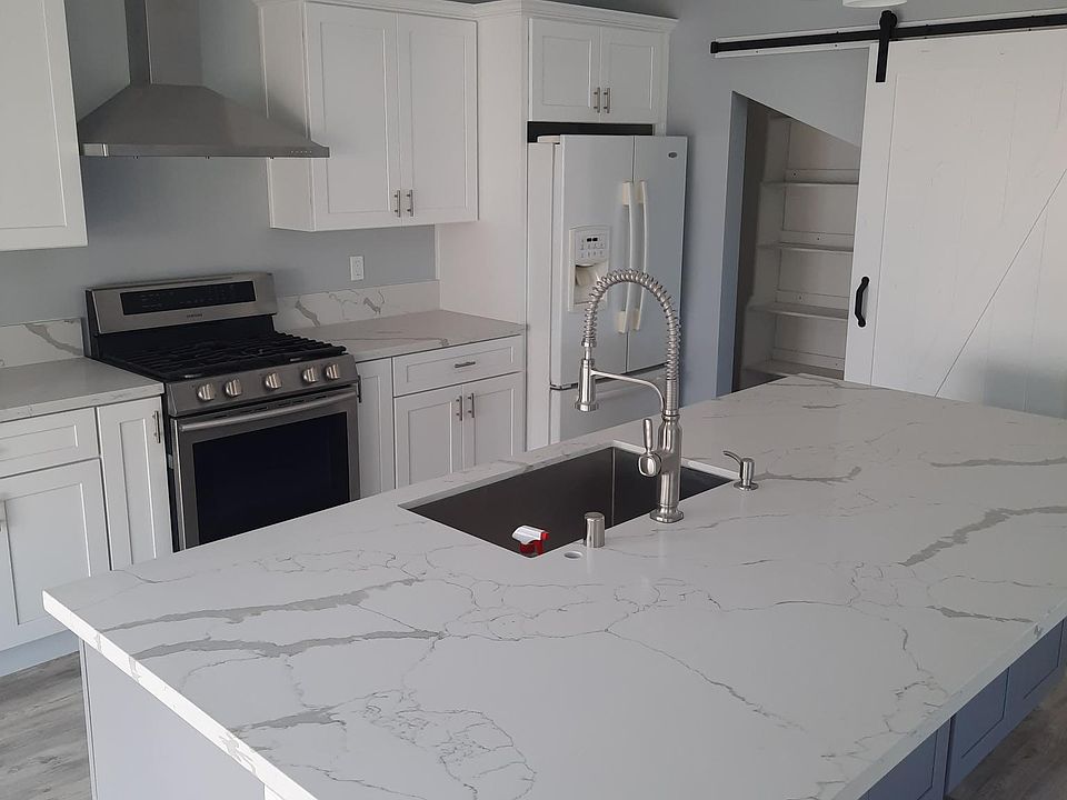 Kitchen with sliding barn doors to the pantry.