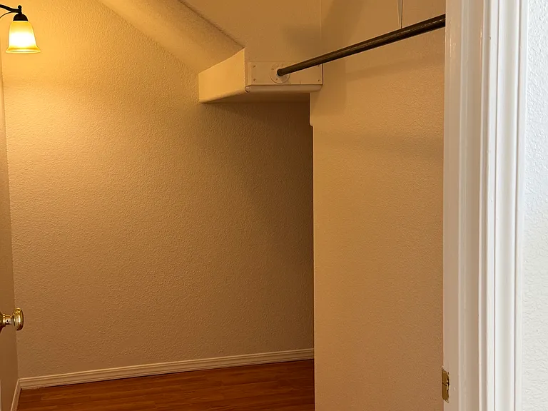 Really, really, big Entry Closet with storage in front and around corner