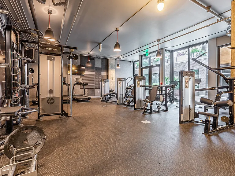 Resident Fitness Studio with Training Stations and Cardio Machines
