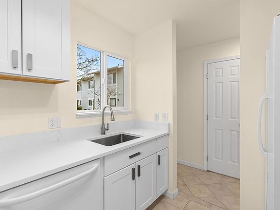 Kitchen just off entry hallway with window overlooking front walkway