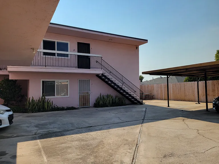 One of two stairways going upstairs to Unit 4, 5 and 6 and down to parking and shared laundry room, picnic table and place for plants (not in photo).