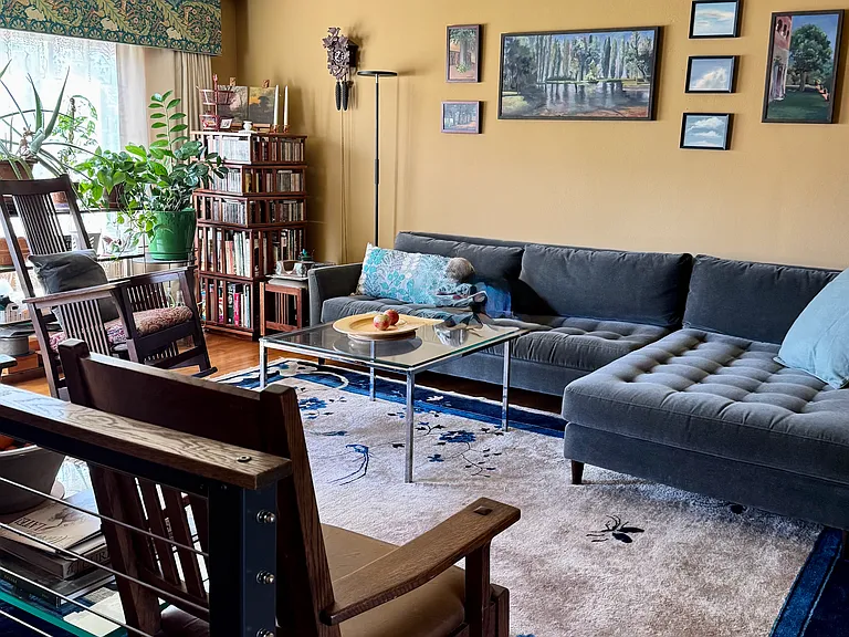 Living room with sectional sofa - in foreground is railing leading to basement