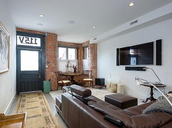 Living room with 55_ HDTV AND 9.1 speakers. Roche Bobois leather sectional