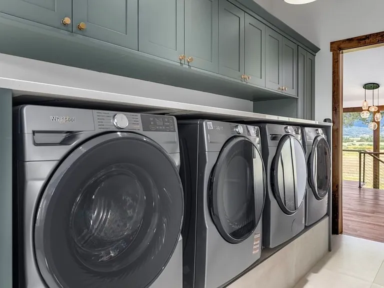 4 raised washer/dryer combos with custom cabinetry and ample storage