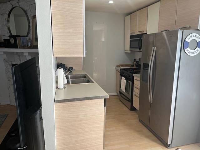 Kitchen-- modern and stylish with a stunning stainless steel refrigerator., dishwasher, large stove/oven, and a large overhead microwave.