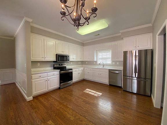 Spacious eat in kitchen, newly painted with brand new stainless steel appliances.