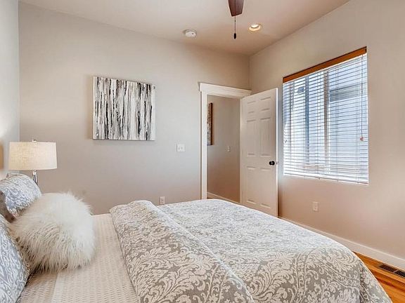 Spacious master bedroom, with plenty of natural light. View facing into kitchen and living room hallway where master bathroom is located.