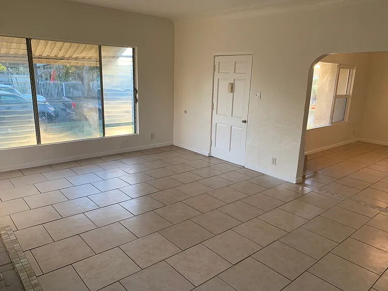 Enter front door into a charming and spacious, well lit living room.