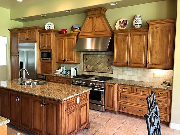Kitchen. Gas stove with 6 burners. Dual oven. Massive cabinet space/storage. Breakfast bar to the left. Kitchen nook to the right.