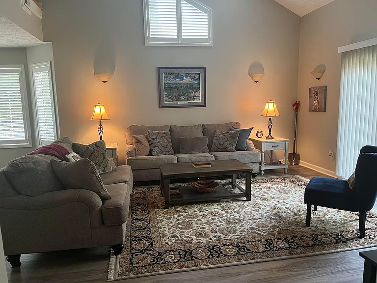 Large living room with sliding glass doors to outside patio