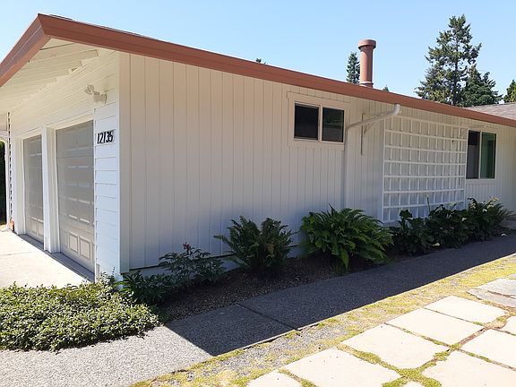 Unit A attached garage on left side. Garage door on right belongs to unit B. A wall between the 2 garages divides them.