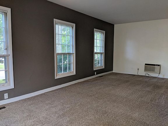 Living room w/ through-the-wall air-conditioning unit