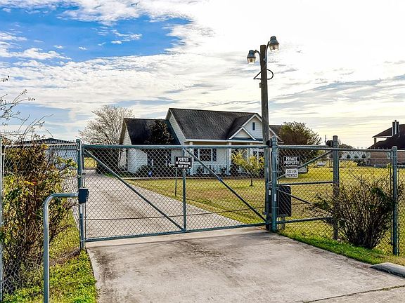 Automatic security gate and commercial grade cyclone fencing surrounding the property. Crossed fenced.