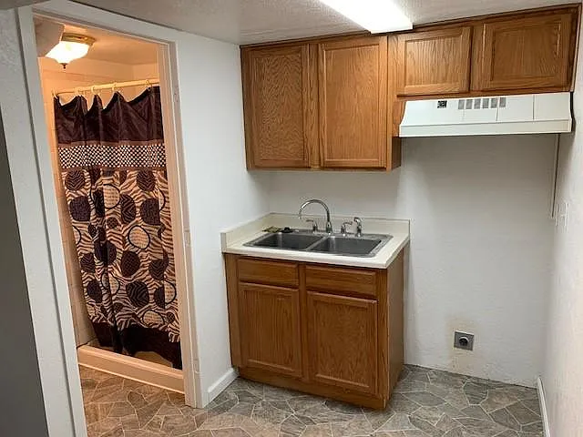 kitchenette showing open area for additional small appliances and entrance to bathroom