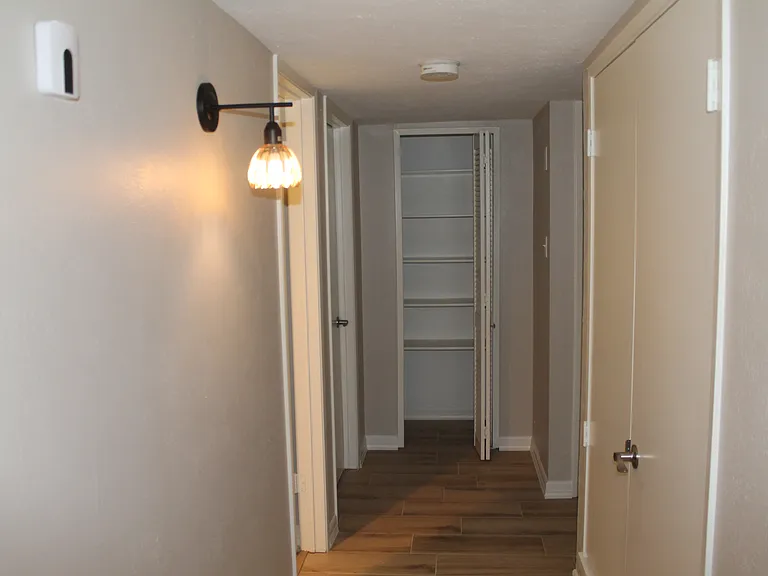 Private hallway heading to all bedrooms and the hall bathroom with an added closet space