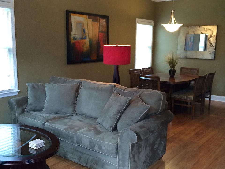 Open living/dining room floorplan with hardwood floors.
