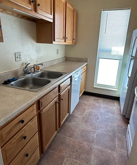 Galley Style Kitchen with Passthrough Window to Dining Area...