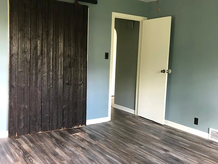 Master bedroom with closet door closed.