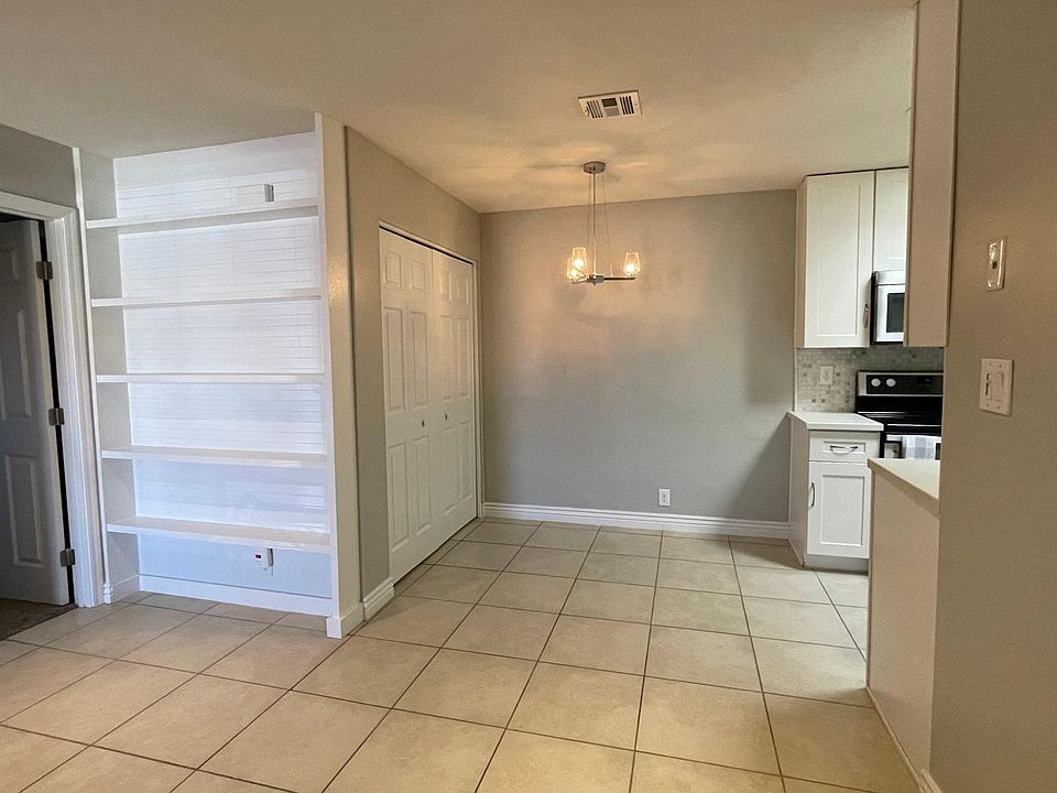 View inside front door. Living room to dining room to kitchen. Master bedroom door.