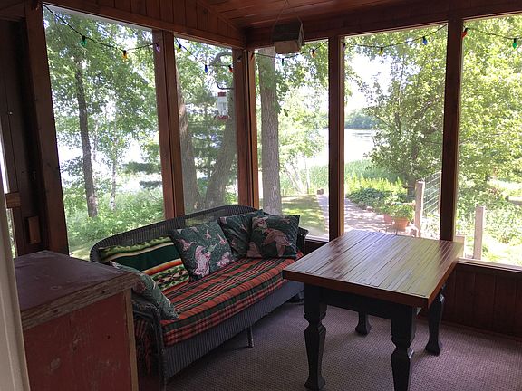 Screen porch overlooks lake.