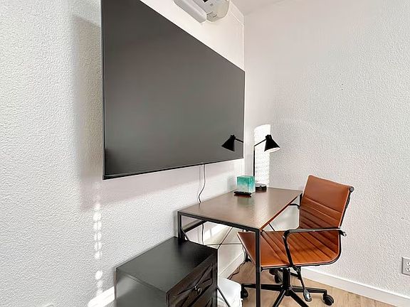 (Private Bedroom Workspace) Comfortable workspace with a desk and chair for remote work or study.