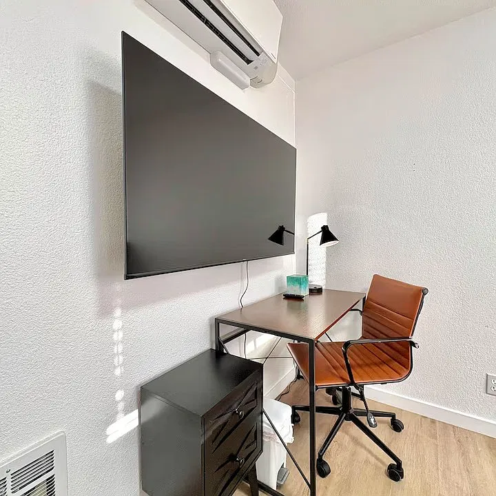 (Private Bedroom Workspace) Comfortable workspace with a desk and chair for remote work or study.