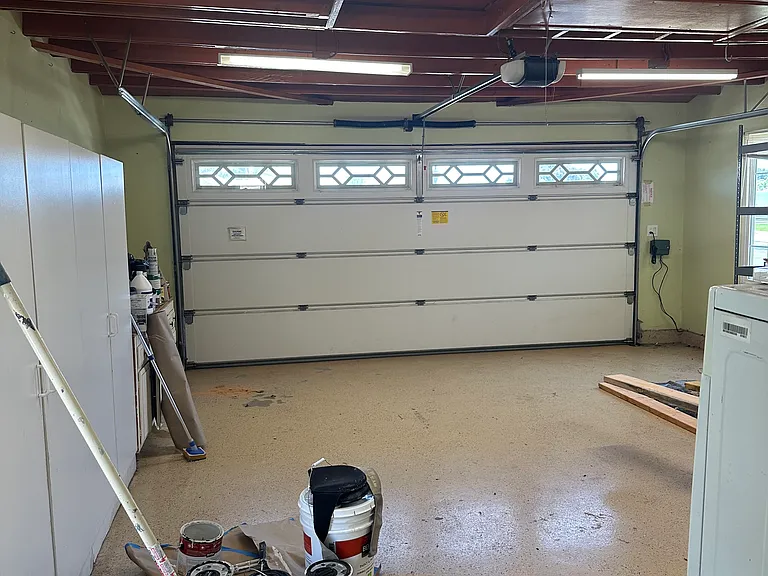 Garage with plenty of shelves and storage. Includes washer and dryer.