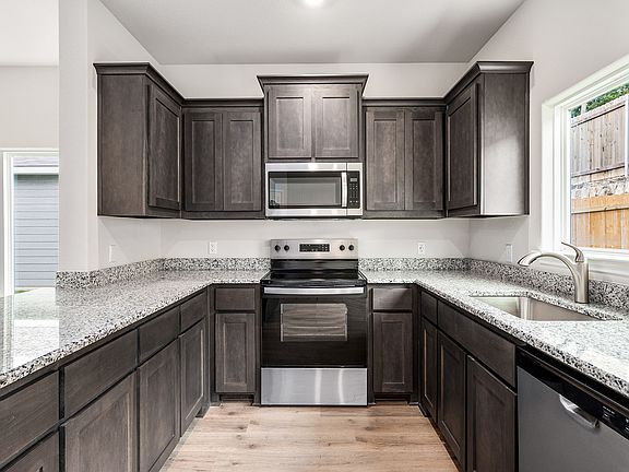 The kitchen has sprawling granite countertops.