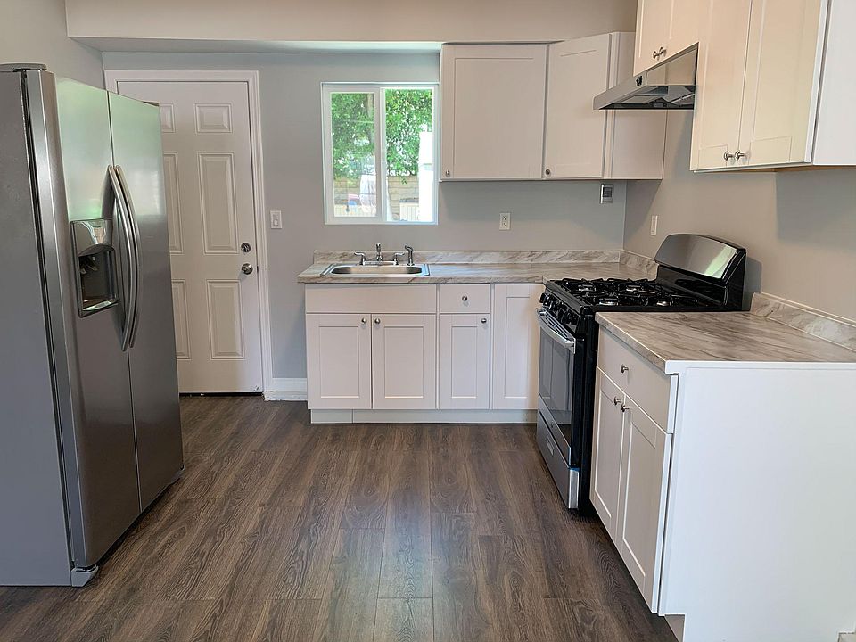 Kitchen with door leading to backyard.