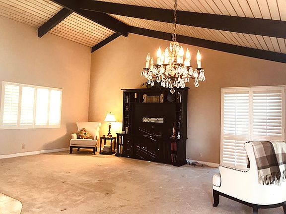 Large vaulted ceiling living room with plantation shutters