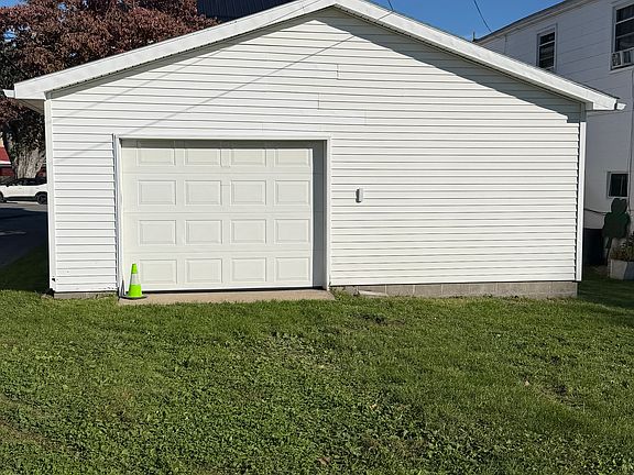 Oversized detached garage. Single car door, but a lot of extra room