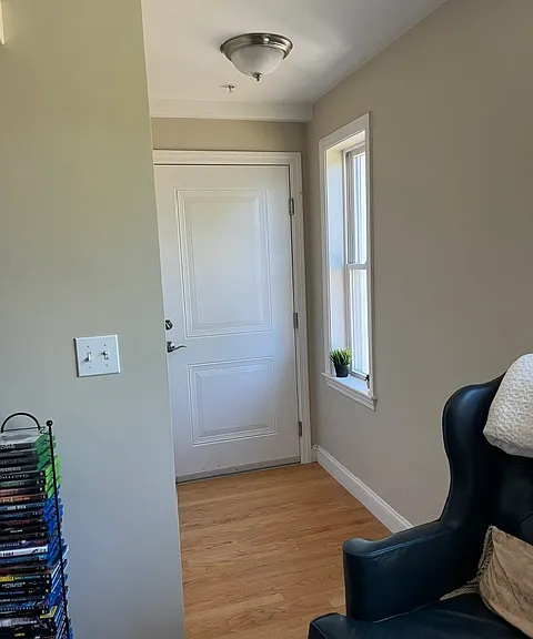 Front entrance that leads to open concept living/kitchen area. There is a large, double with closet opposite the window.