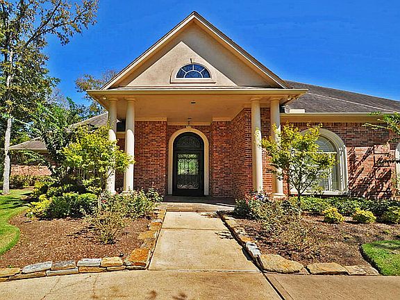 Over sized, solid and enhanced with scrolling iron work, this front door is unique and elegant,