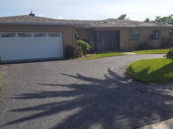 THE FRONT HAS A CIRCULAR DRIVEWAY AND A LARGE 2.5 CAR GARAGE