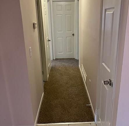 Hallway leading to bedrooms and bathrooms.